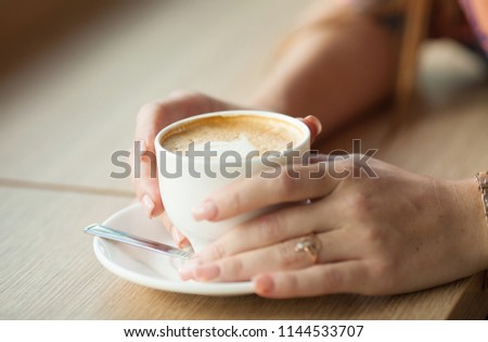 Hand Holding Latte Coffee With Heart Shape