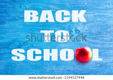 Back to school. The inscription on a blue wooden background. Education. Backgrounds.