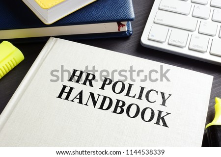HR policy handbook on an office desk. Royalty-Free Stock Photo #1144538339