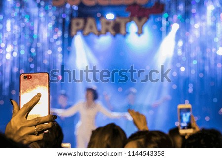 Concert crowd, People enjoying a Party Concert with people are using mobile camera, blur picture, selective focus