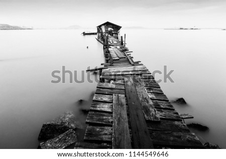 Long exposure black and white shot of a wooden old jetty