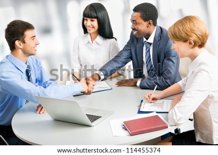 Business people shaking hands, finishing up a meeting Royalty-Free Stock Photo #114455374