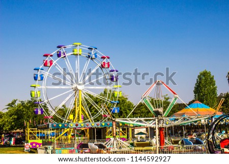 Amusement Rides At Local County Fair Royalty-Free Stock Photo #1144592927