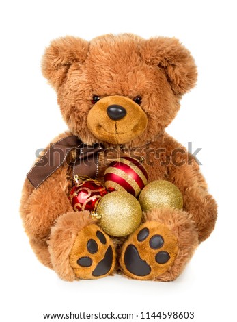 Toy teddy bear with christmas balls isolated on white background