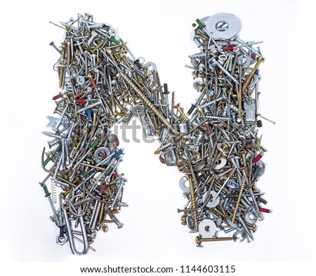 A lot of cogs, screws,  bolts and moods on a white background. Latin alphabet letter. 