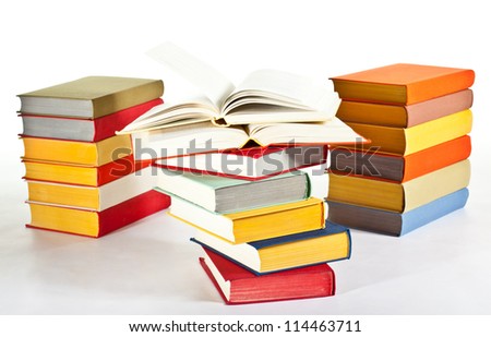 Many multicolored stacked books on neutral background