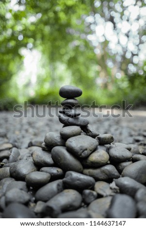 Pile of stones in equilibrium in the forest, blur background.