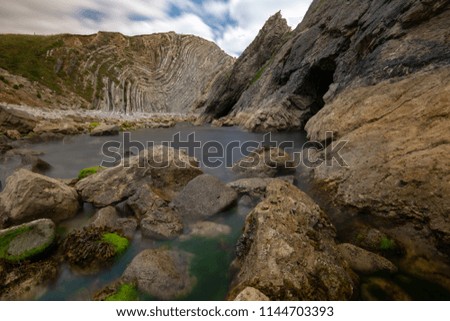 Rocks in the water in front of the Stair Hole, near Lulworth, Dorset, UK