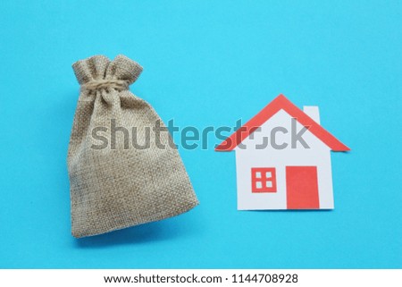Paper cut of house red roof on brown background with money bag,top view. 