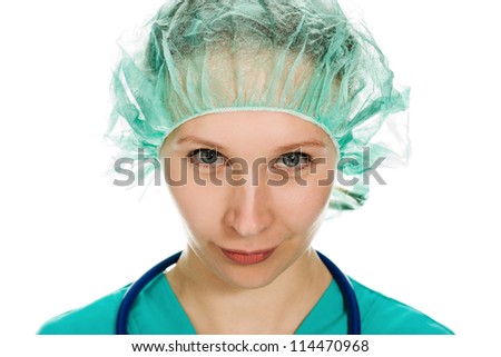 Beautiful woman surgeon angrily looks at a white background.