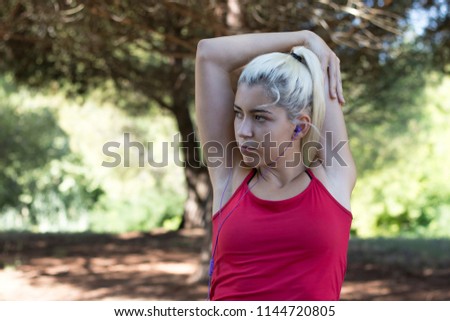 Pretty young girl exercising in the forest