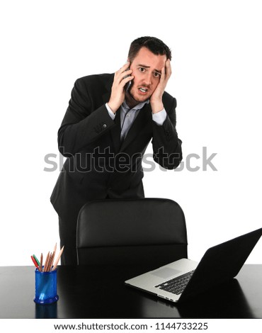 Worried business man speaking on the phone in his office against a white background