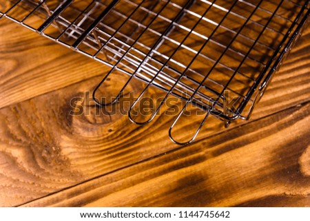 Empty barbecue grill on rustic wooden table