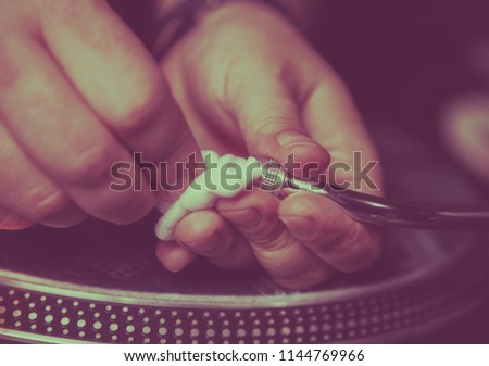 Hands of dj cleaning professional turn tables needle cartridge from dust