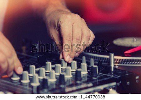 Concert dj mixing music with sound mixer. Hip hop disc jockey playing set on concert with vinyl records player and audio mixer controller