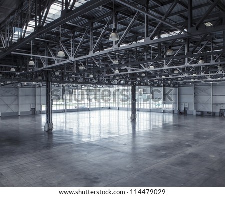 Interior of an empty warehouse with glass wall Royalty-Free Stock Photo #114479029