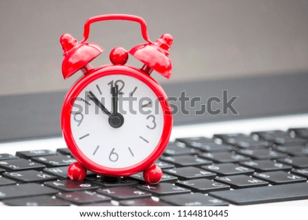 Red clock on the keyboard, lunch time
