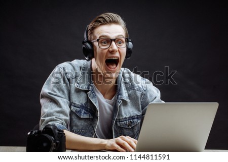 student in glasses and headphones shreaking with laughter