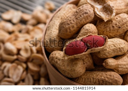 fresh peanuts on a wooden rustic background