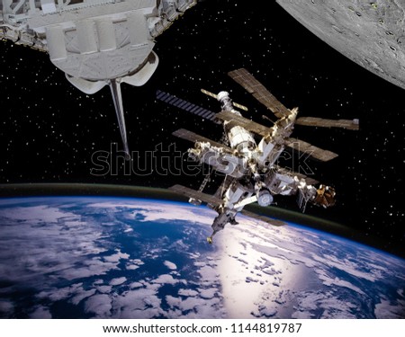 Space station, earth and planet with craters like moon. The elements of this image furnished by NASA.
