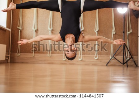 hanging upside down pose with stretching twine. full length photo