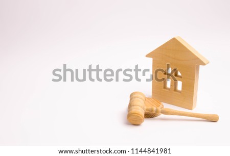 Wooden house and hammer of the judge on a white background. Concept trial property. The court decision on the transfer of property, nationalization of property. Legal assistance in matters of estate