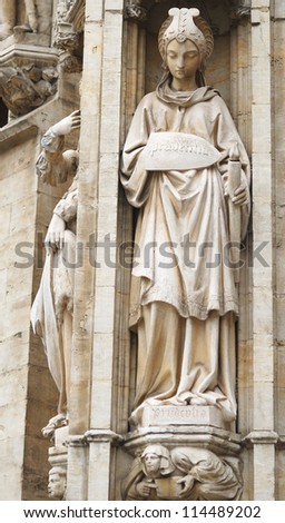 Statue of Prudence decorating gothic facade of City Hall on Grand Place in Brussels, Belgium