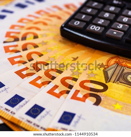 Euro Money. euro cash background. Lots of Euro money on the calculator. Euro banknotes background of Euros of Europe, EUR currency. Financial colorful background.