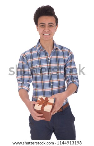 Cute teenager giving a gift and smiling isolated on a white background