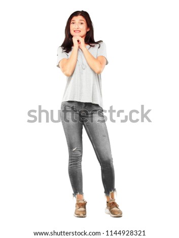 young pretty girl full body with a stressed gesture, with both hands clenched half covering face.