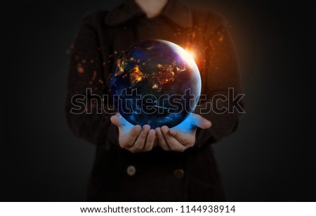Earth at night was holding in human hands for Earth day and Energy saving concept,Elements of this image furnished by NASA