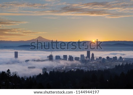 Sunrise over City of Portland Oregon and Mount Hood Covered in Low Fog Banks