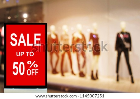 big sale 50% mock up advertise billboard or advertising light box with blurred image of popular fashion clothes shop showcase in department store, commercial, marketing and advertisement concept