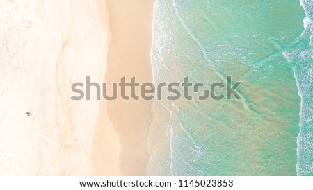 Surf Beach Aerial, Beach on aerial drone top view with ocean waves reaching shore, top view aerial photo from flying drone of an amazingly beautiful sea landscape. Ocean Wallpaper. 