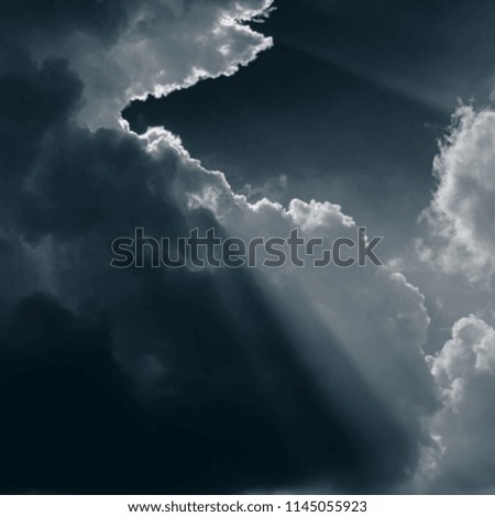 Blurred background. Dark clouds and sunrays. A square web banner.
