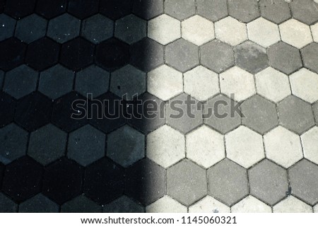 A picture of road tiles divided between shaded area and direct sunlight at Kuala Lumpur,Malaysia.