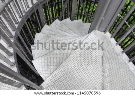 Steel spiral staircase with steel
 battens on natural background