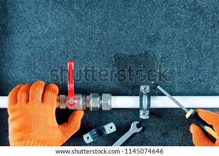  Repair plumbing pipes background.Hand plumber holding faucet, tools for repair plumbing. Royalty-Free Stock Photo #1145074646