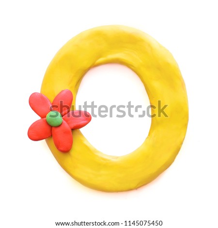 Yellow plasticine letter O English alphabet with red flower, isolate on white background