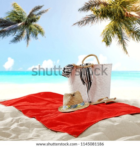 Towel on sand and free space for your decoration. Landscape with ocean and two palms. 