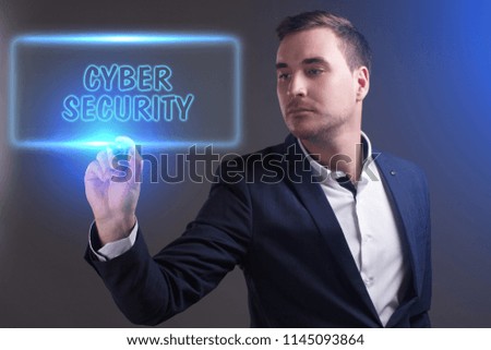 The concept of business, technology, the Internet and the network. Young businessman showing inscription: Cyber security