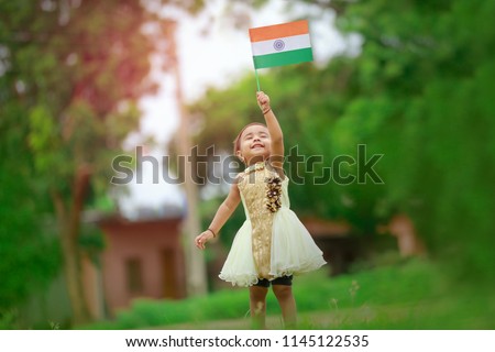 indian girl child holding indian flag Royalty-Free Stock Photo #1145122535