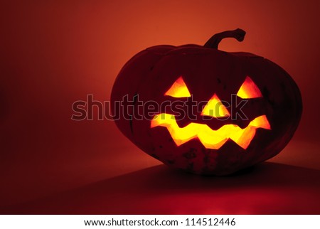Glowing pumpkin with a candle inside. Decorations for Halloween.