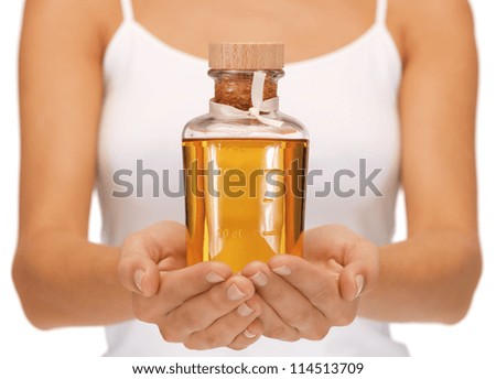bright picture of female hands with oil bottle