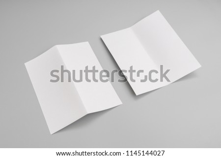 Bifold white template paper on blue background.
