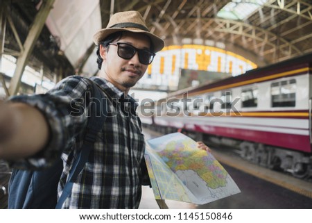 Asian man bag pack tourist take a selfie in railway station at Thailand. 