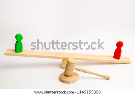 wooden figures of people. rivals in business stand on the scales. competition. trial. conflict. victory and defeat. bad and good worker. concept of success and power. the court's decision