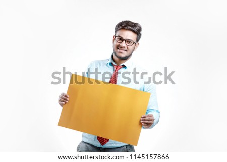 happy Young indian man showing blank poster