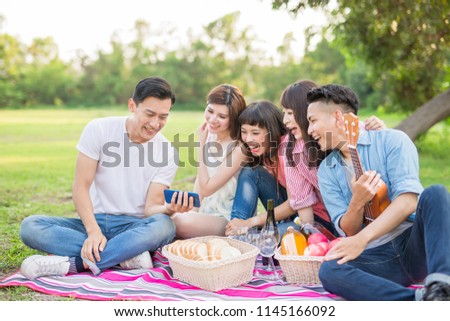 people use phone happily and enjoy go on a picnic