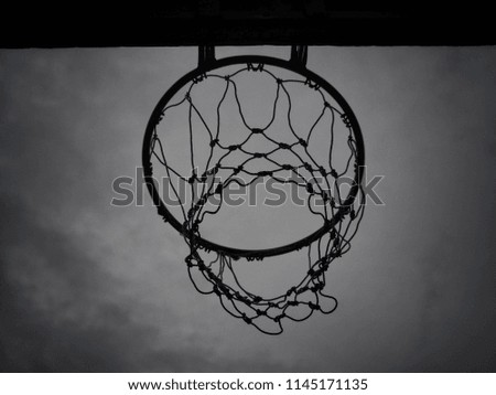 Photo angle of basketball hoops on the board, there is a backdrop of dark sky in the evening